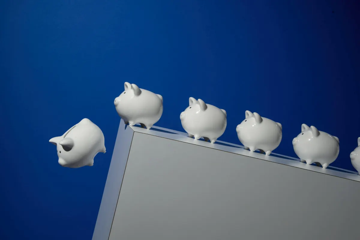 Row of piggy banks on a ledge